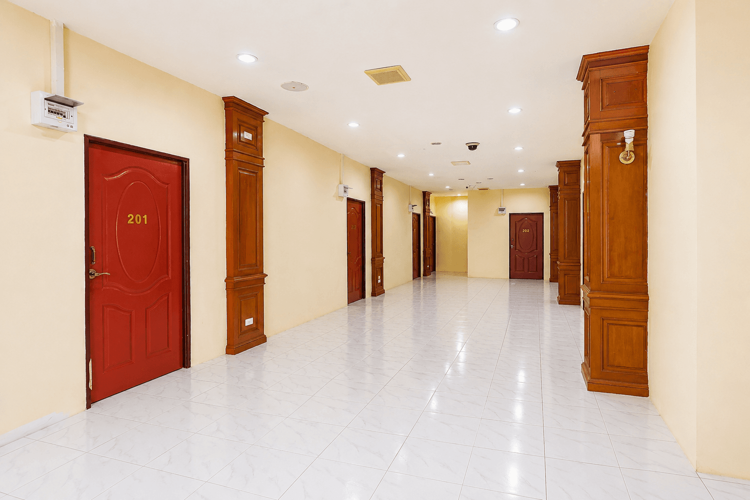 Bright guest corridor with warm timber details