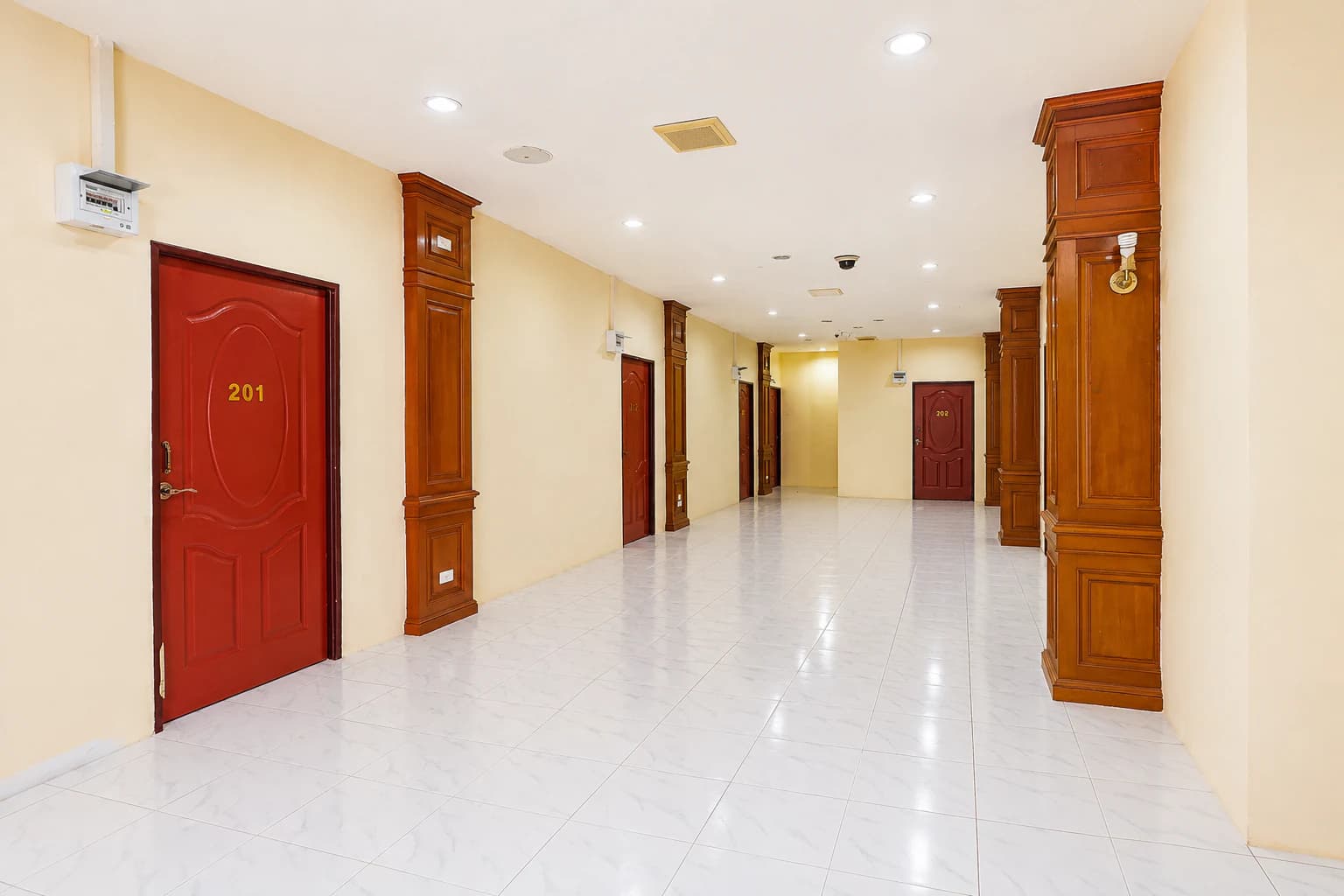 Bright guest corridor with warm timber details