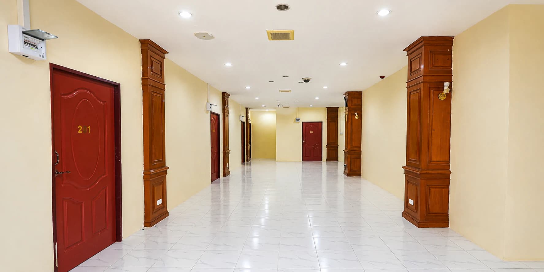 Spacious hotel corridor leading to guest rooms